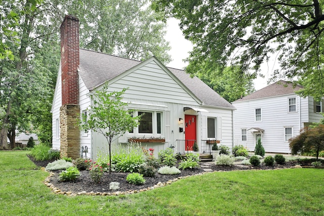 595 Brookside Dr, Columbus, OH 43209 - view of front of property featuring roof with shingles, a chimney, and a front lawn