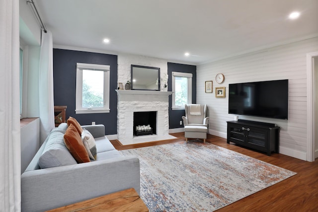 595 Brookside Dr, Columbus, OH 43209 - living area with a stone fireplace, wood finished floors, crown molding, and recessed lighting