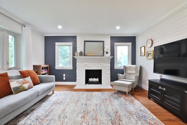 595 Brookside Dr, Columbus, OH 43209 - living area with crown molding, a stone fireplace, wood finished floors, and recessed lighting