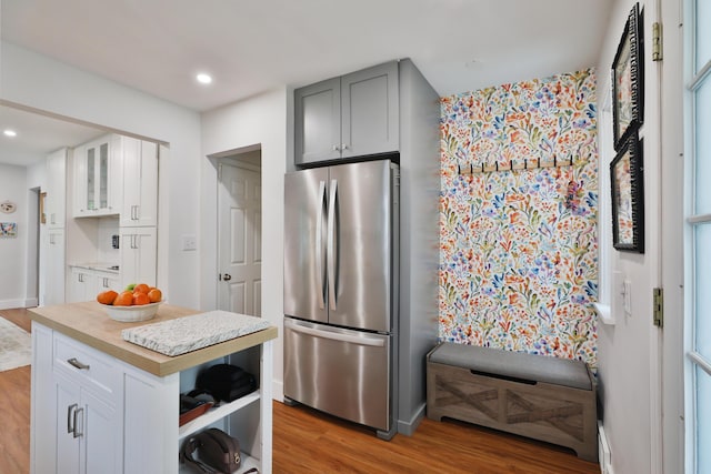595 Brookside Dr, Columbus, OH 43209 - kitchen featuring freestanding refrigerator, light wood-type flooring, light countertops, glass insert cabinets, and white cabinets