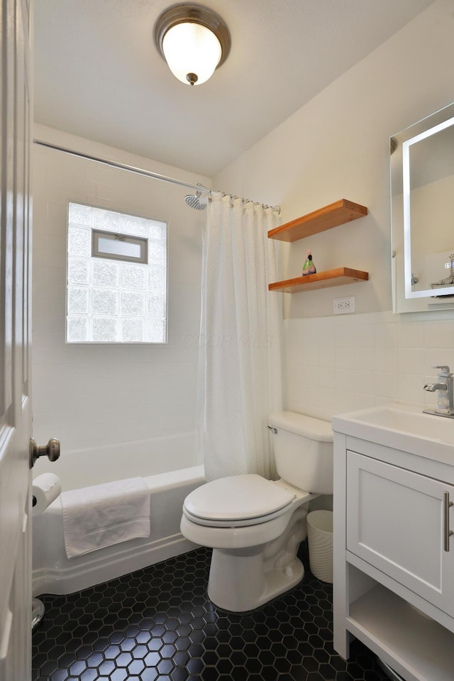 595 Brookside Dr, Columbus, OH 43209 - bathroom with vanity, shower / bathtub combination with curtain, tile patterned flooring, and tile walls