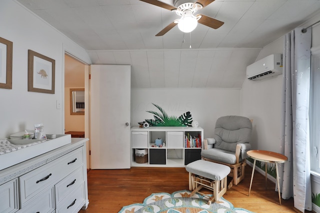 595 Brookside Dr, Columbus, OH 43209 - sitting room with a wall mounted AC, wood finished floors, and ceiling fan