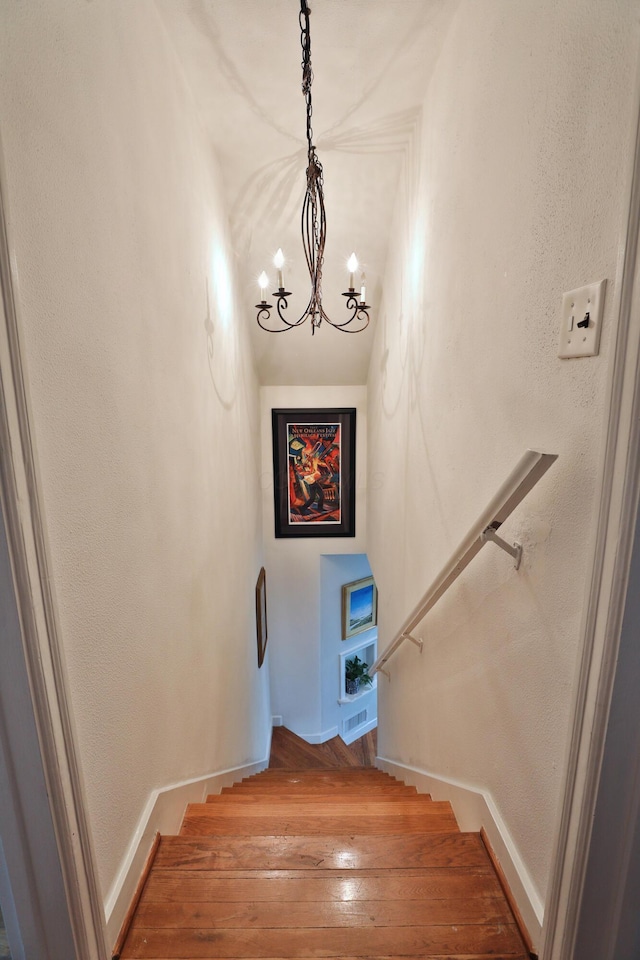 595 Brookside Dr, Columbus, OH 43209 - staircase with a chandelier and wood-type flooring