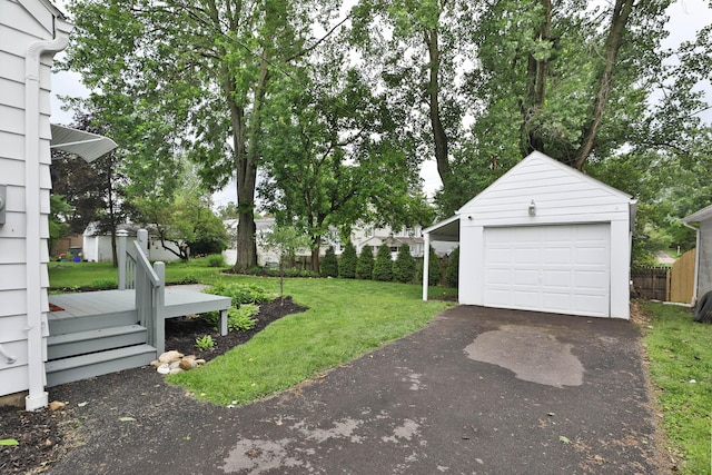 595 Brookside Dr, Columbus, OH 43209 - view of yard featuring an outbuilding, a wooden deck, a detached garage, and asphalt driveway