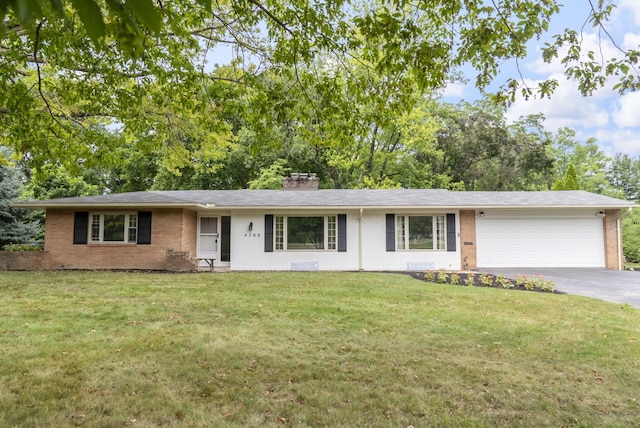 4289 Shelbourne Ln, Columbus, OH 43220 - ranch-style house with brick siding, asphalt driveway, an attached garage, and a chimney