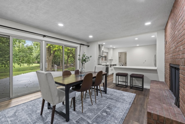 4289 Shelbourne Ln, Columbus, OH 43220 - dining area with a textured ceiling, dark wood-type flooring, a fireplace, and recessed lighting