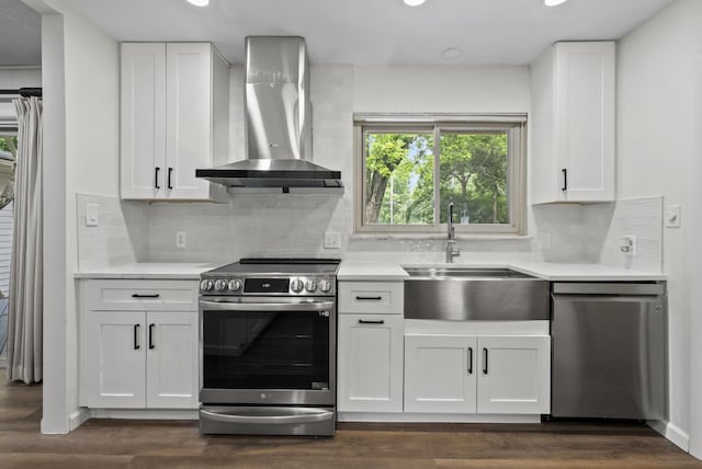 4289 Shelbourne Ln, Columbus, OH 43220 - kitchen with wall chimney exhaust hood, stainless steel appliances, recessed lighting, and light countertops