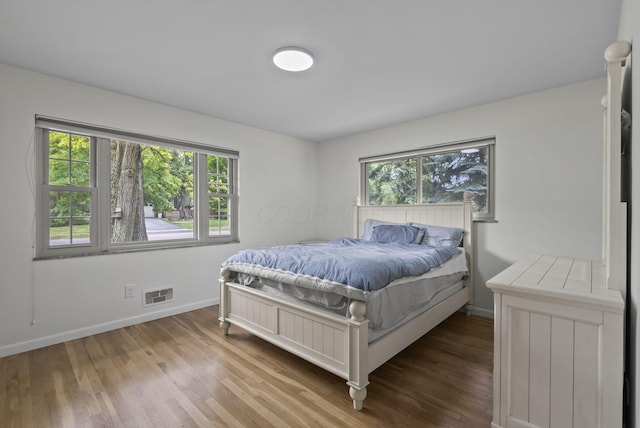 4289 Shelbourne Ln, Columbus, OH 43220 - bedroom featuring multiple windows and wood finished floors