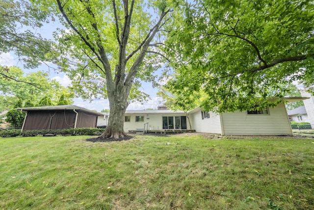 4289 Shelbourne Ln, Columbus, OH 43220 - rear view of house featuring a lawn and a sunroom