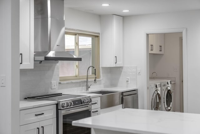4289 Shelbourne Ln, Columbus, OH 43220 - kitchen with washing machine and dryer, stainless steel electric range oven, island range hood, tasteful backsplash, and recessed lighting