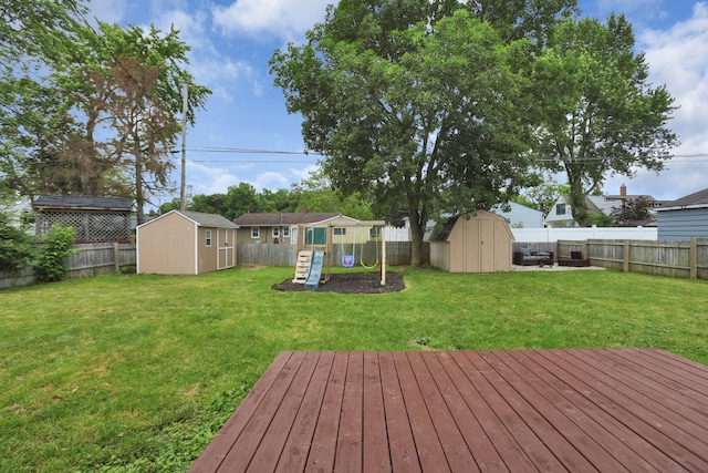 372 Sturbridge Rd, Columbus, OH 43228 - wooden deck with a storage shed, a fenced backyard, and a playground