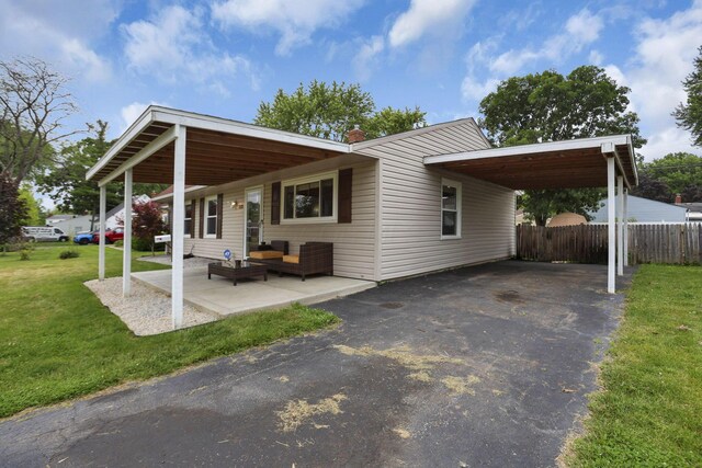 372 Sturbridge Rd, Columbus, OH 43228 - view of front of home with outdoor lounge area, driveway, and an attached carport