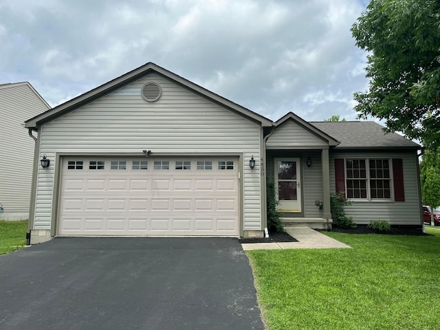 4450 Nickerson Rd, Columbus, OH 43228 - ranch-style house with driveway, an attached garage, and a front yard