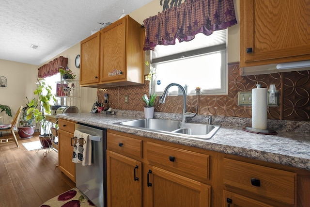 50 Bazler Ln, South Bloomfield, OH 43103 - kitchen with stainless steel dishwasher, a textured ceiling, dark wood finished floors, plenty of natural light, and brown cabinets