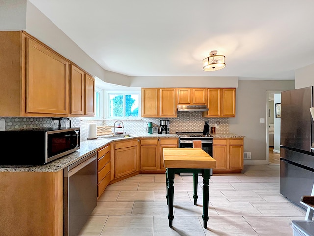 4713 Haughn Rd, Grove City, OH 43123 - kitchen with stainless steel appliances, under cabinet range hood, decorative backsplash, and light stone countertops