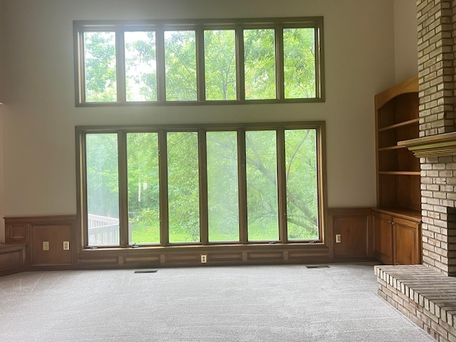 471 Old Mill Dr, Columbus, OH 43230 - unfurnished living room with a towering ceiling, carpet, a decorative wall, a wainscoted wall, and built in features