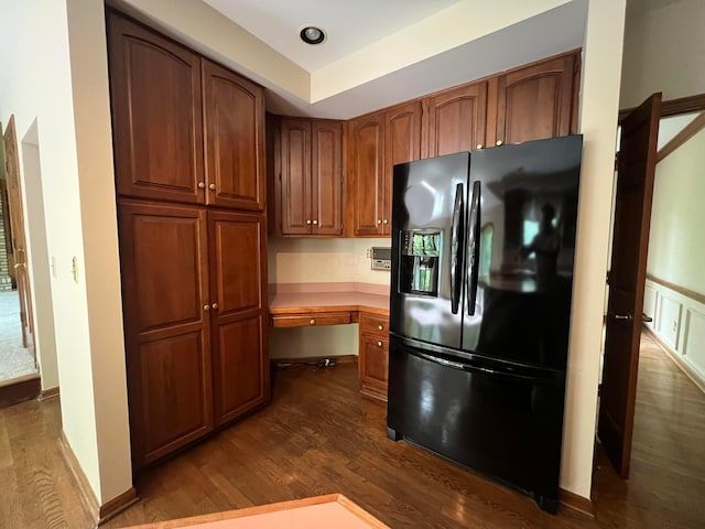 471 Old Mill Dr, Columbus, OH 43230 - kitchen with black fridge, dark wood-style flooring, brown cabinetry, and light countertops