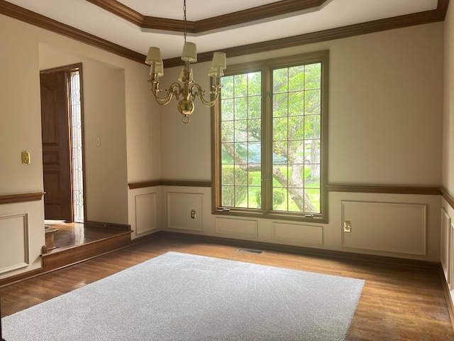 471 Old Mill Dr, Columbus, OH 43230 - unfurnished dining area featuring a chandelier, ornamental molding, wainscoting, a tray ceiling, and wood finished floors