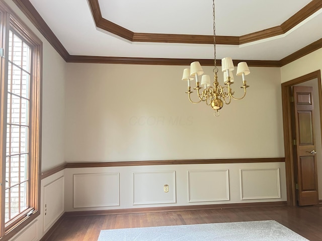 471 Old Mill Dr, Columbus, OH 43230 - unfurnished dining area featuring plenty of natural light, a chandelier, a wainscoted wall, wood finished floors, and a raised ceiling