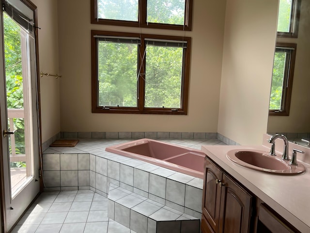 471 Old Mill Dr, Columbus, OH 43230 - bathroom with a relaxing tiled tub, vanity, and healthy amount of natural light