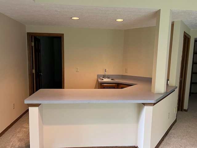 471 Old Mill Dr, Columbus, OH 43230 - kitchen with light colored carpet, a textured ceiling, recessed lighting, a peninsula, and light countertops