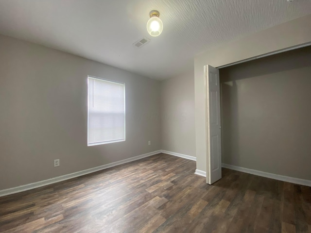 128 S Princeton Ave, Columbus, OH 43222 - unfurnished bedroom featuring dark wood-style flooring and a closet