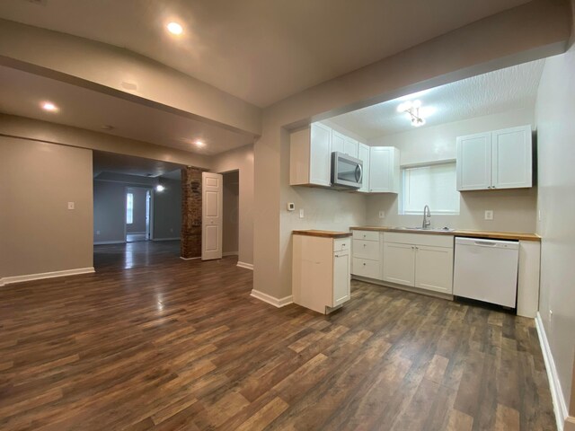 128 S Princeton Ave, Columbus, OH 43222 - kitchen featuring white dishwasher, stainless steel microwave, dark wood-type flooring, white cabinetry, and open floor plan