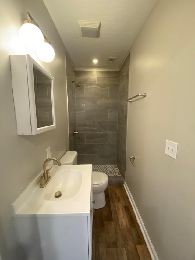 128 S Princeton Ave, Columbus, OH 43222 - bathroom with a stall shower, wood finished floors, and vanity