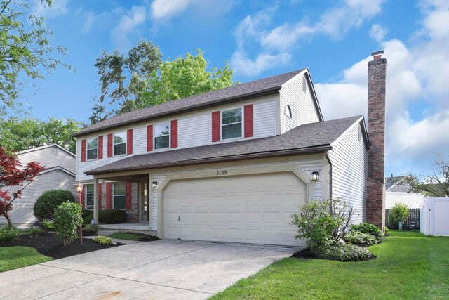 8139 Storrow Dr, Westerville, OH 43081 - traditional-style home featuring concrete driveway, an attached garage, a front yard, and a chimney