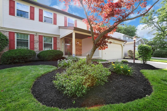 8139 Storrow Dr, Westerville, OH 43081 - view of front of home featuring concrete driveway, a front lawn, covered porch, and an attached garage