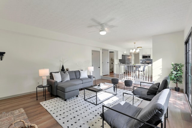 8139 Storrow Dr, Westerville, OH 43081 - living area featuring a chandelier, ceiling fan, a textured ceiling, and wood finished floors