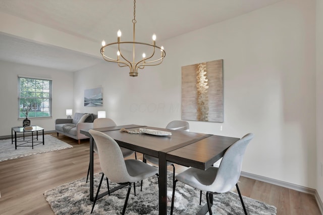 8139 Storrow Dr, Westerville, OH 43081 - dining room featuring a chandelier and light wood-style floors