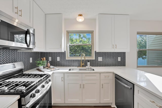 8139 Storrow Dr, Westerville, OH 43081 - kitchen with stainless steel appliances, white cabinetry, and tasteful backsplash