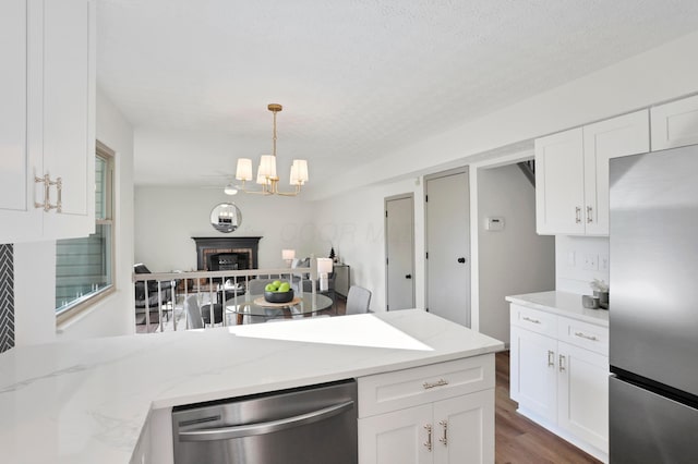 8139 Storrow Dr, Westerville, OH 43081 - kitchen with appliances with stainless steel finishes, white cabinetry, a chandelier, and wood finished floors