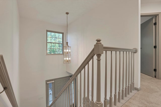 8139 Storrow Dr, Westerville, OH 43081 - stairs with a chandelier and carpet flooring