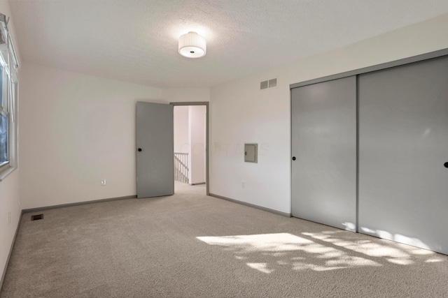 8139 Storrow Dr, Westerville, OH 43081 - unfurnished bedroom featuring light carpet, a closet, and a textured ceiling