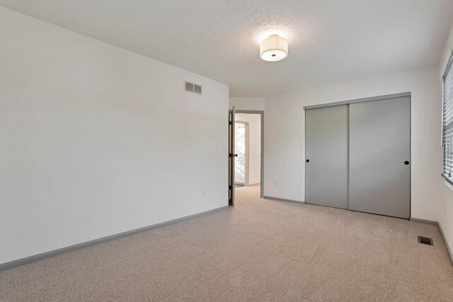 8139 Storrow Dr, Westerville, OH 43081 - unfurnished bedroom with carpet floors, a closet, and a textured ceiling