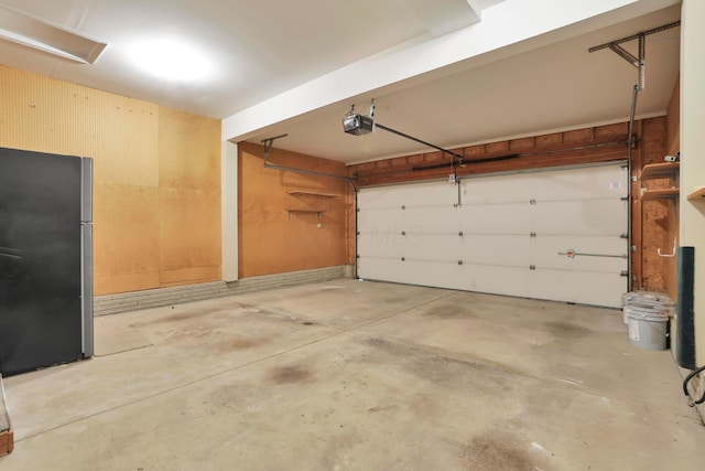 8139 Storrow Dr, Westerville, OH 43081 - garage featuring freestanding refrigerator and a garage door opener