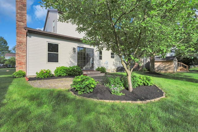 8139 Storrow Dr, Westerville, OH 43081 - back of property featuring a chimney, a yard, and a storage shed