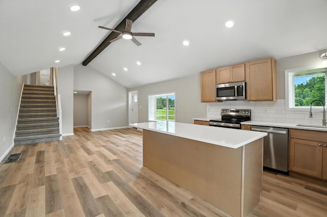 4615 County Road 23, Cardington, OH 43315 - kitchen with appliances with stainless steel finishes, a kitchen island, tasteful backsplash, light countertops, and light wood-style flooring