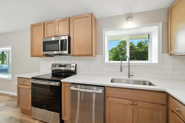 4615 County Road 23, Cardington, OH 43315 - kitchen with stainless steel appliances, decorative backsplash, light countertops, and plenty of natural light