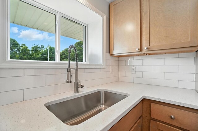 4615 County Road 23, Cardington, OH 43315 - kitchen with backsplash, light stone counters, and brown cabinetry