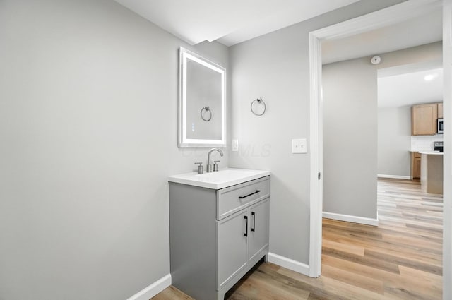 4615 County Road 23, Cardington, OH 43315 - bathroom featuring wood finished floors, vanity, and decorative backsplash