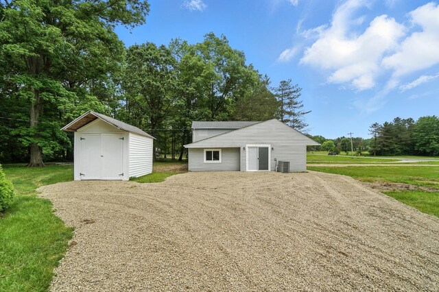 4615 County Road 23, Cardington, OH 43315 - garage featuring a shed, driveway, and view of wooded area