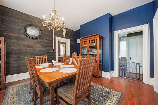 1871 Galloway Rd, Galloway, OH 43119 - dining space featuring a chandelier, hardwood / wood-style flooring, and wooden walls