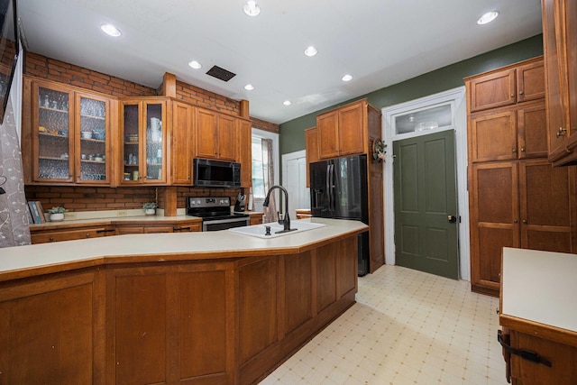 1871 Galloway Rd, Galloway, OH 43119 - kitchen with black appliances, light countertops, brown cabinets, glass insert cabinets, and recessed lighting