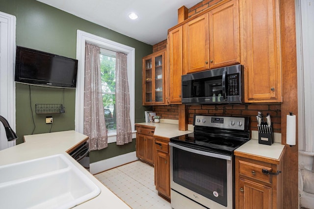 1871 Galloway Rd, Galloway, OH 43119 - kitchen featuring stainless steel appliances, light countertops, decorative backsplash, glass insert cabinets, and recessed lighting