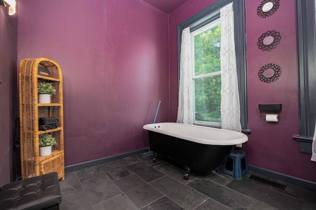 1871 Galloway Rd, Galloway, OH 43119 - bathroom with a soaking tub and stone finish floors