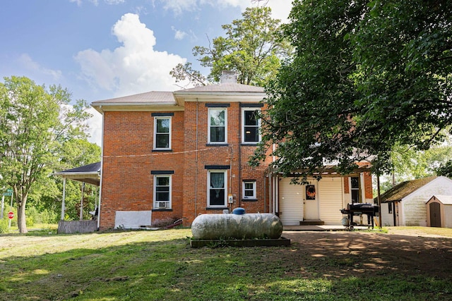 1871 Galloway Rd, Galloway, OH 43119 - view of front of house featuring a storage unit, brick siding, a front lawn, and a chimney