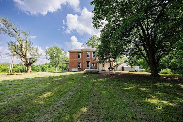 1871 Galloway Rd, Galloway, OH 43119 - back of property with brick siding, a yard, and a patio area